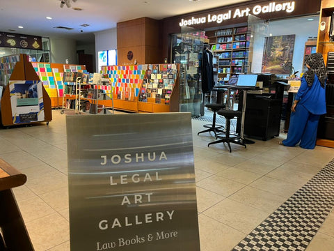 Interior of Joshua Legal Art Gallery with books and art displayed.
